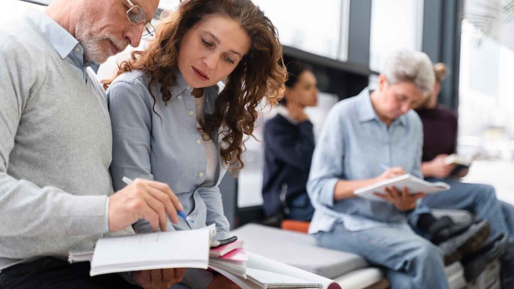Grup de persones escribint en llibretes